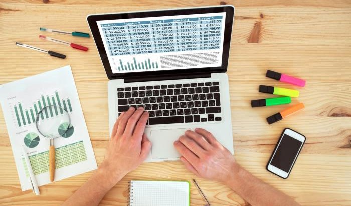 Organised workspace with laptop and data materials